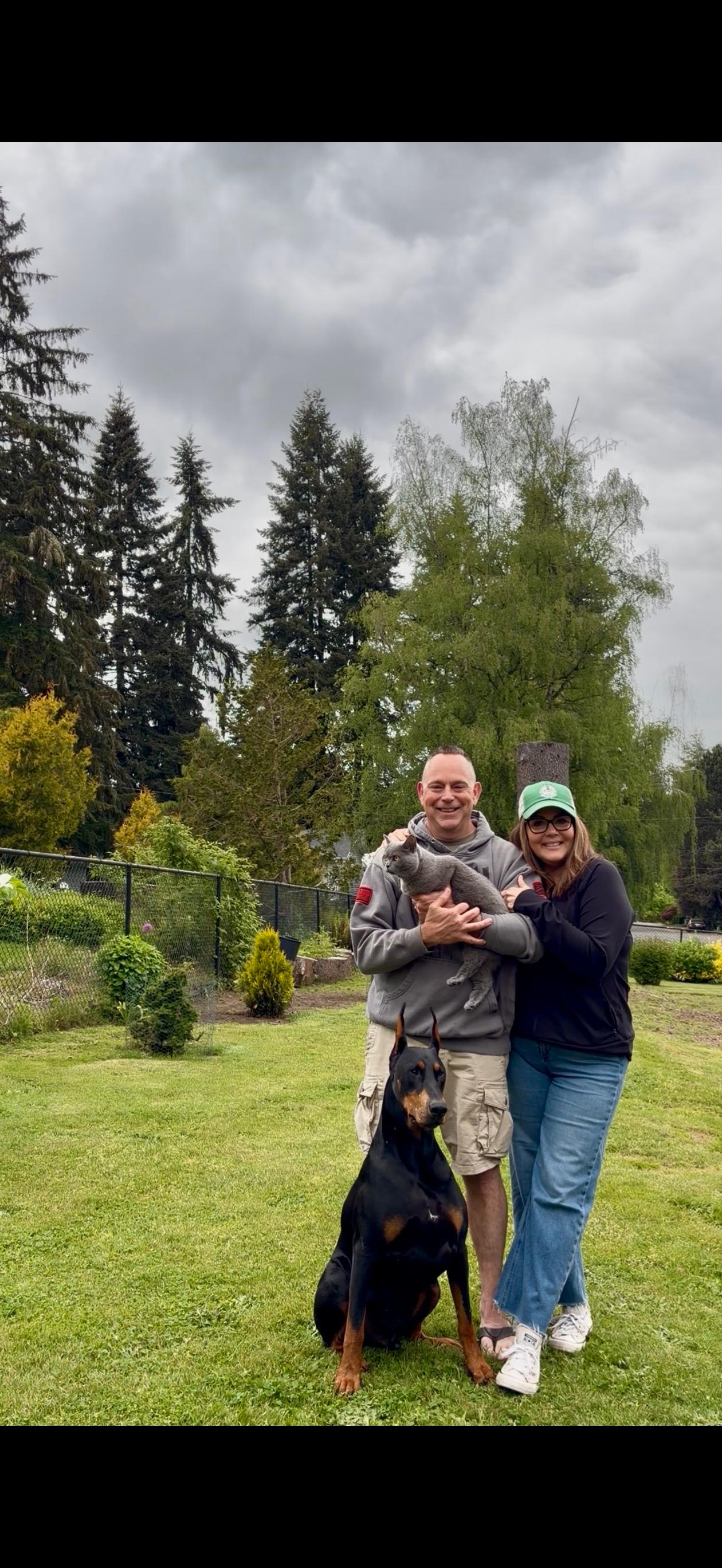 I Got You Poo owners smiling with dogs in a local yard